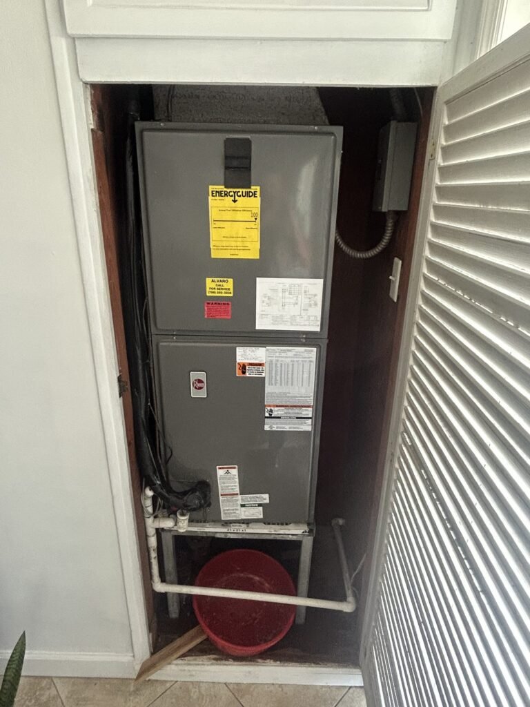 Old air handler in closet before replacement