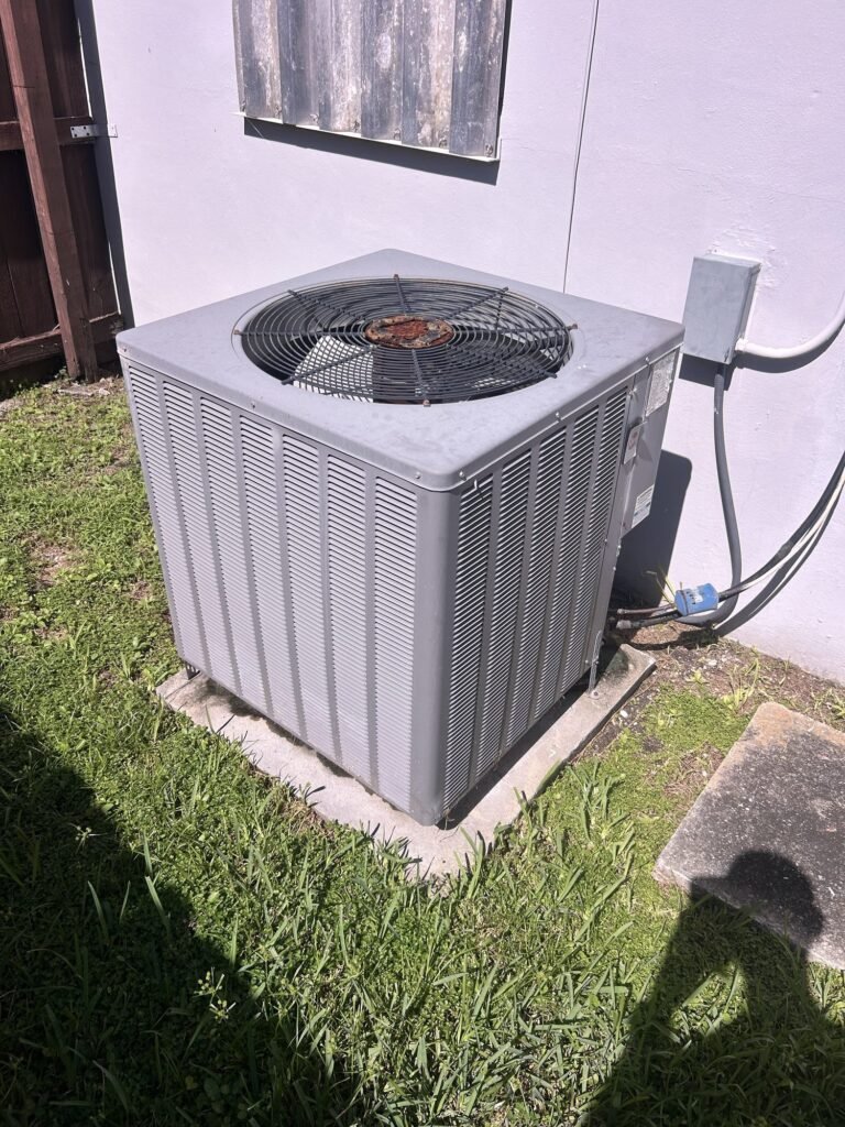 Old outdoor AC condenser before replacement