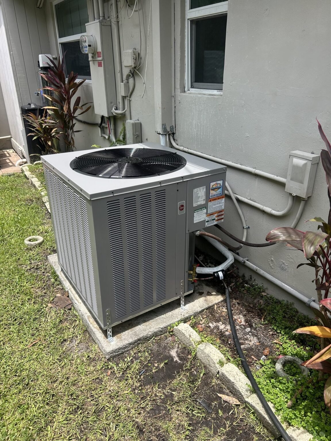 New Rheem air conditioning condenser installed outside a South Florida home